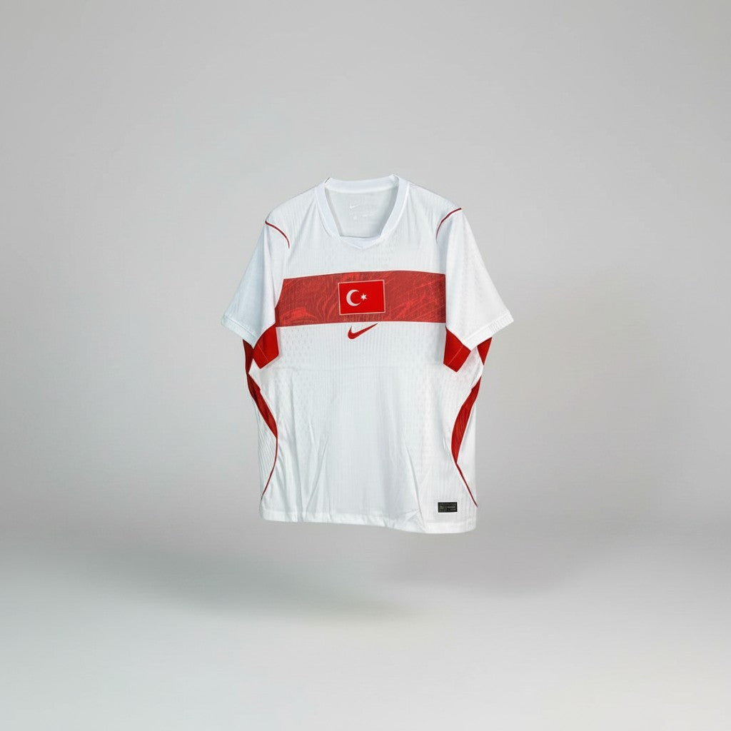 White football jersey with red horizontal chest band, crescent and star emblem, and red curved side panels