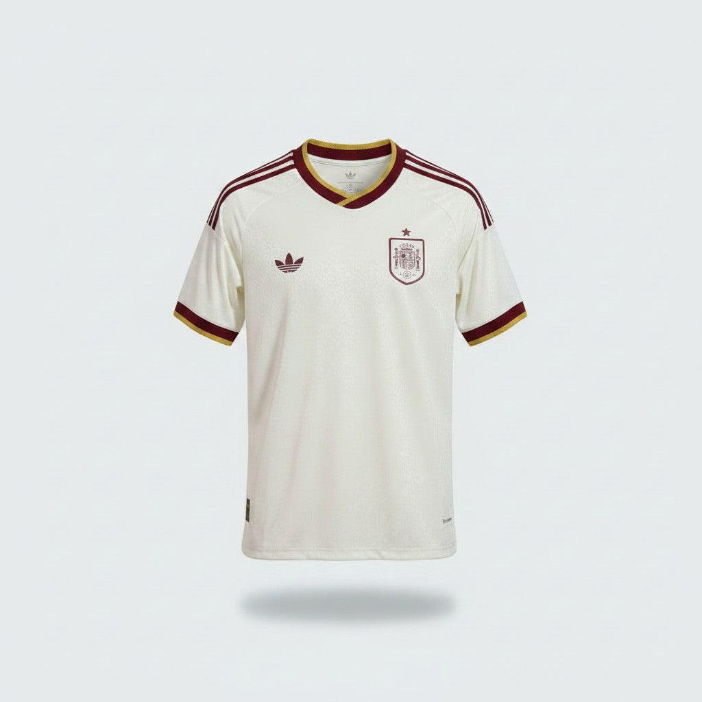 Off-white cream football jersey with dark maroon V-neck collar, gold trim, three-stripe shoulders and embroidered crest