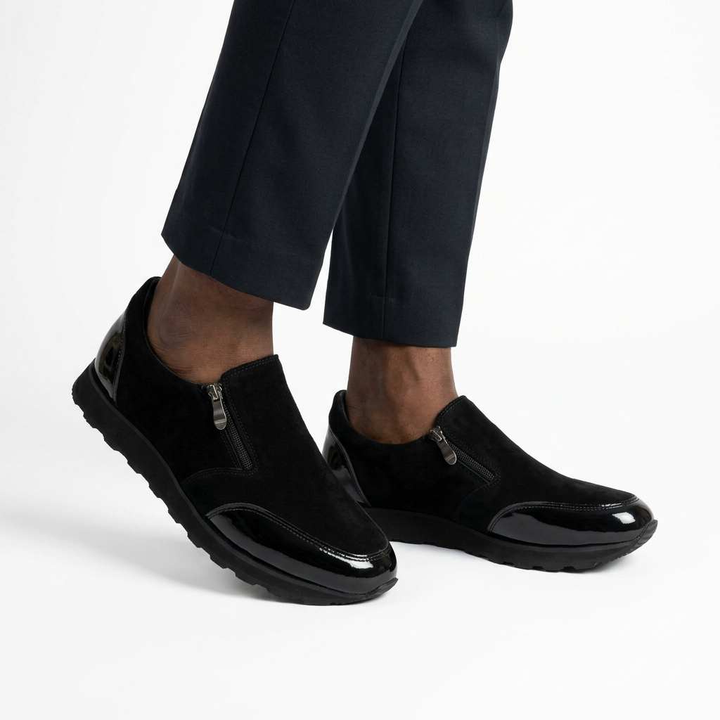 Black zip-detail slip-ons on a model