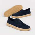 Catalog shot of navy suede lace-up sneakers, unbranded