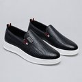 Pair of black woven-texture slip-on shoes with white soles