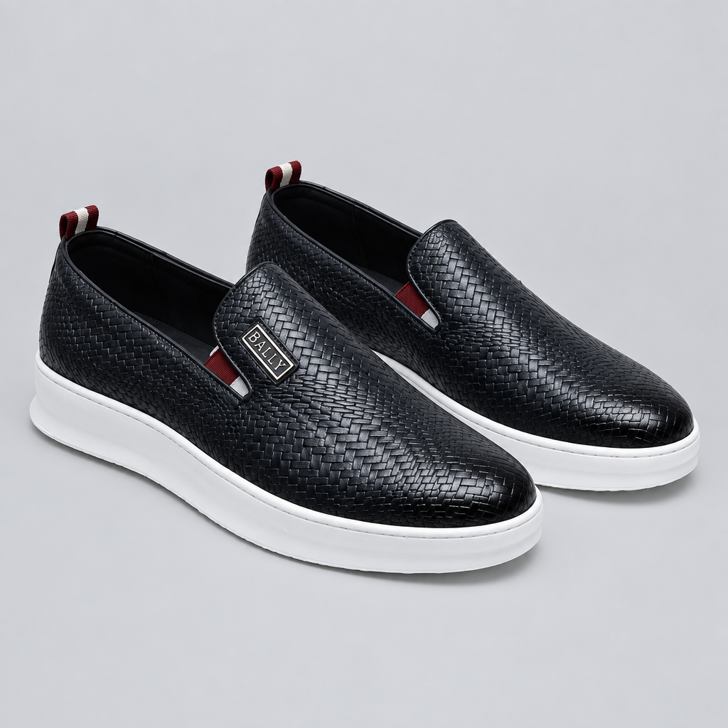 Pair of black woven-texture slip-on shoes with white soles