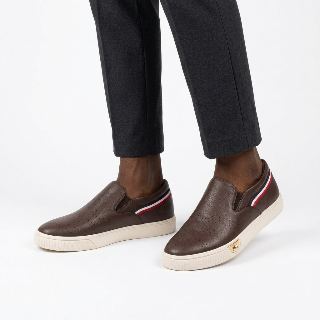 Both brown perforated slip-ons worn with charcoal trousers on white