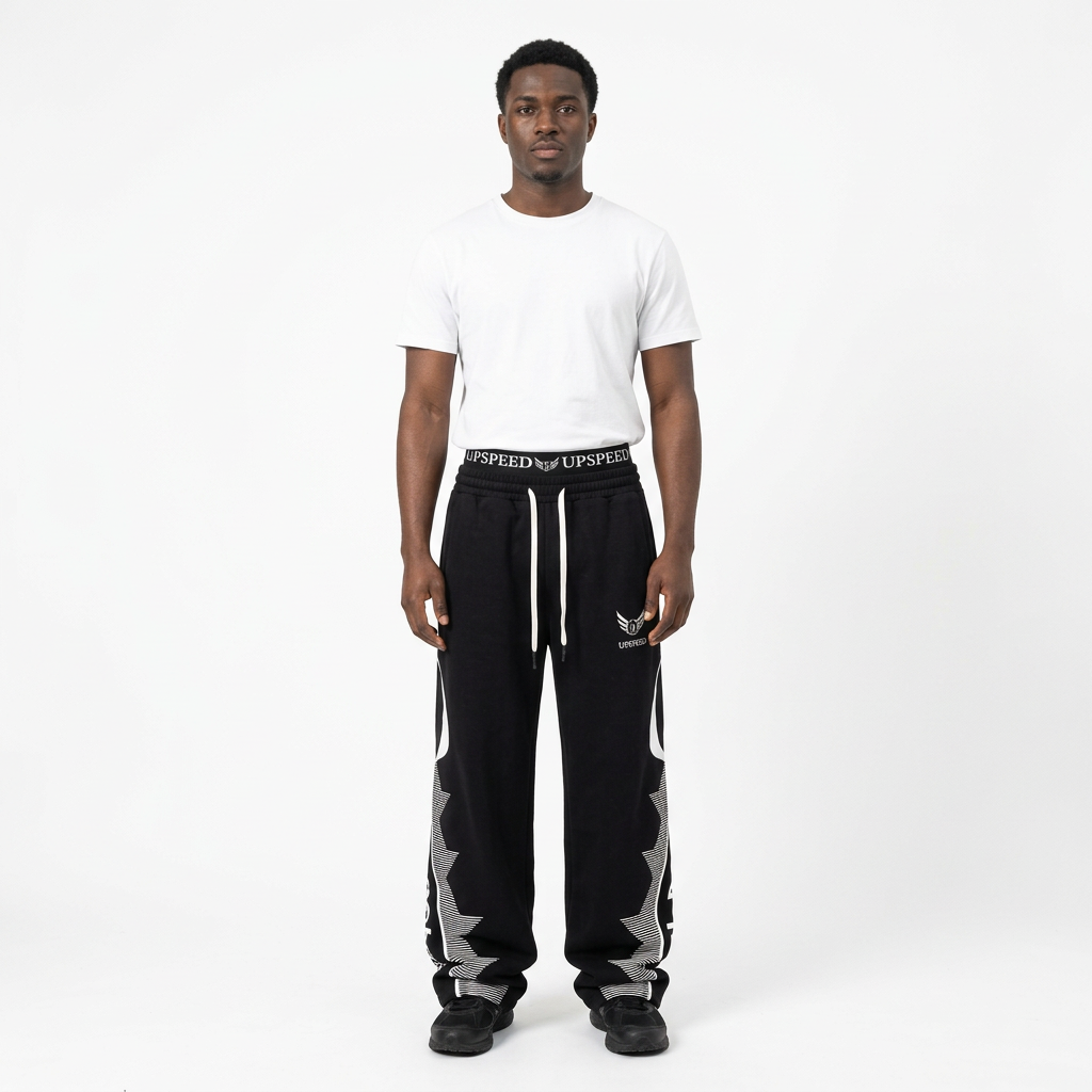 Full-body male model wearing black graphic wide-leg trousers