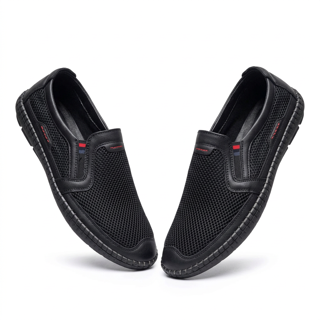 Pair of black mesh red-accent slip-on shoes on white