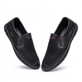 Pair of black mesh red-accent slip-on shoes on white
