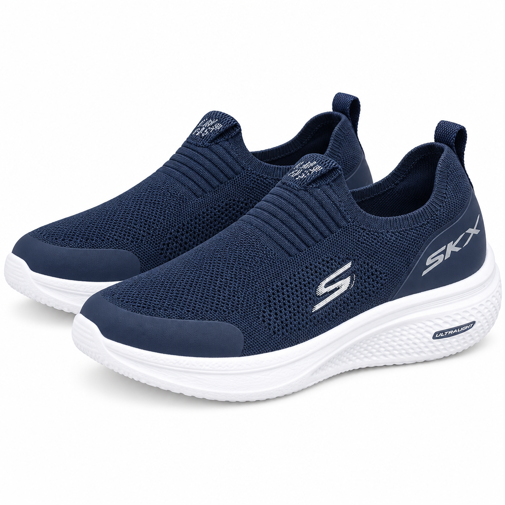 Pair of navy knit slip-on sneakers with sculpted white soles on white