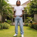 Nigerian male model wearing light blue baggy wide-leg V-panel chevron seam deconstructed denim jeans