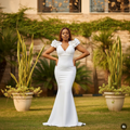 Nigerian female model wearing white ruffle cap sleeve mermaid maxi gown