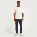 Full-body model wearing a white textured crew-neck T-shirt