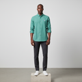 Nigerian male model wearing teal green plain long-sleeved shirt, front view