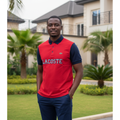 Nigerian male model wearing red and navy two-tone polo shirt in garden setting