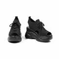 Pair of all-black peep-toe knit high wedge sneakers with tall platform wedge sole on white background