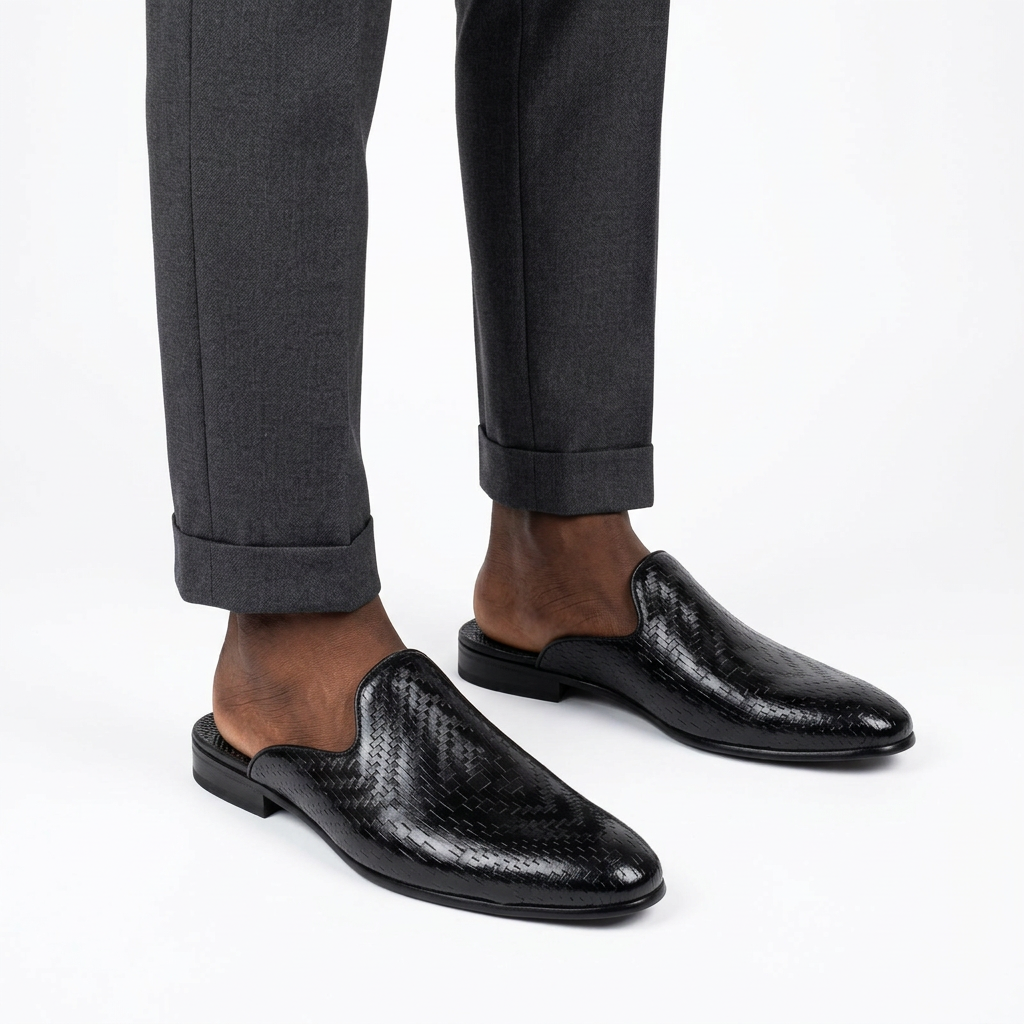 Men’s black textured mule shoes worn with tailored trousers