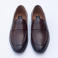 Straight-on dark brown perforated loafers with plain front straps