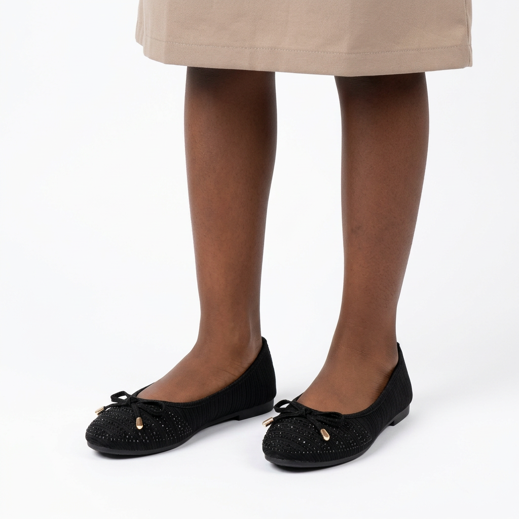 Girl wearing black textured cord-bow ballet flats