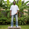 Nigerian male model wearing light blue paint splatter stacked flare jeans – full body lifestyle shot