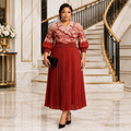Black Nigerian woman wearing red scallop-collar pleated dress