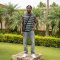 Nigerian male model wearing olive and navy striped sleeveless vest – full body lifestyle shot