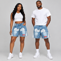 Black Nigerian woman and man together wearing blue and white graphic denim shorts