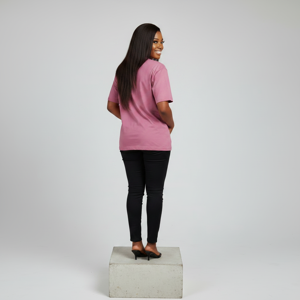 Nigerian female model back view wearing plain dusty pink T-shirt with black trousers - consistent model