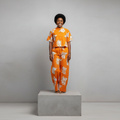 Nigerian female model wearing Orange Adire Floral Shirt and Trouser Set