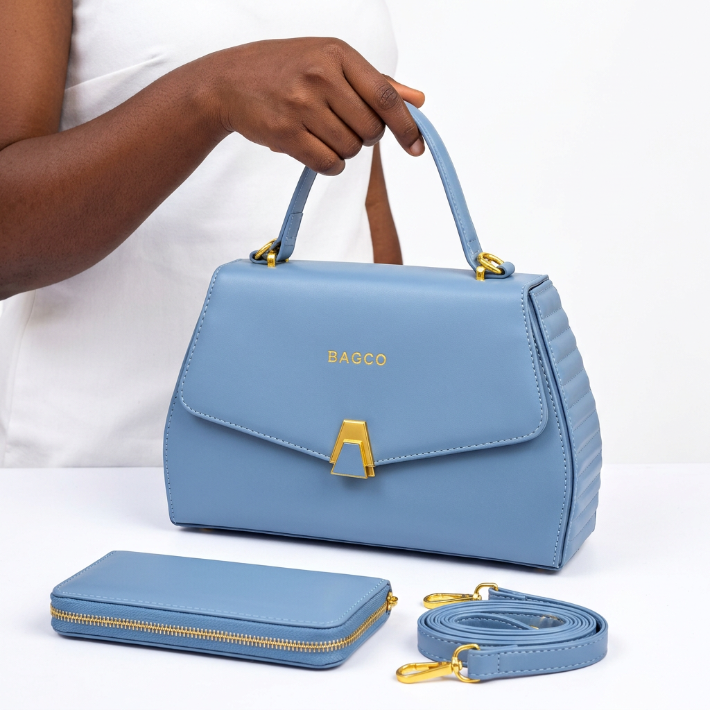 Hand holding a light blue gold-clasp handbag with matching wallet and shoulder strap