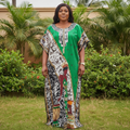 Nigerian woman wearing multicolour bubu dress with green center panel in garden setting