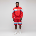 Model wearing the red jacket and shorts set with white and blue stripes