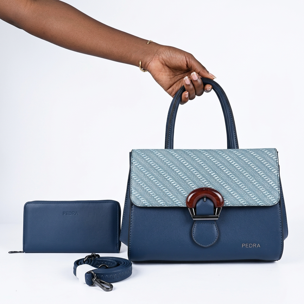 Black woman’s hand holding a navy and pale-blue patterned-flap handbag set