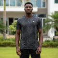 Nigerian male model wearing dark charcoal camo print athletic performance tee