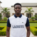 Nigerian male model wearing white and navy two-tone polo shirt in garden setting