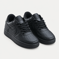 Pair of black textured low-top sneakers with rope laces and perforated toes