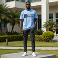 Nigerian male model wearing men's sky blue gothic text graphic short-sleeve tee full body streetwear editorial shot
