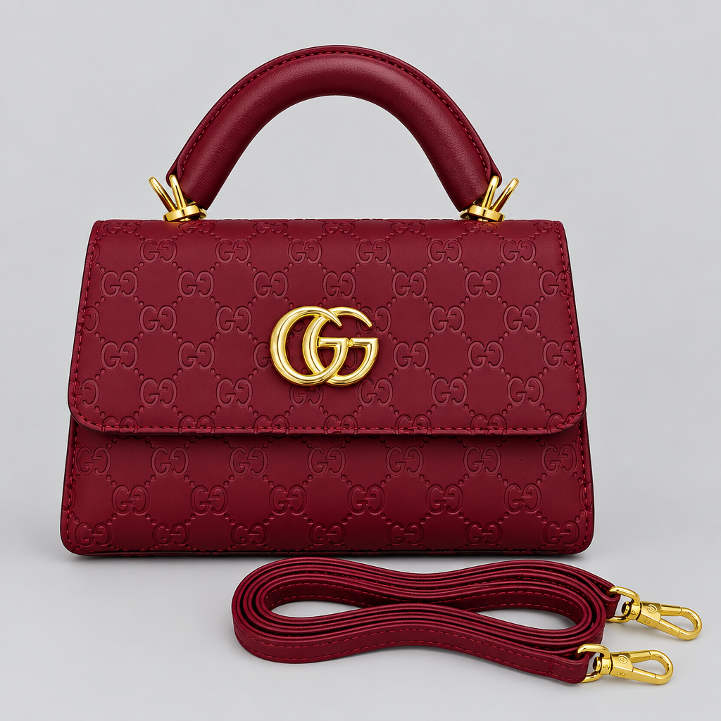 Burgundy embossed top-handle handbag with matching strap