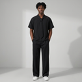 Nigerian male model wearing black tie-neck shirt and wide-leg trouser set
