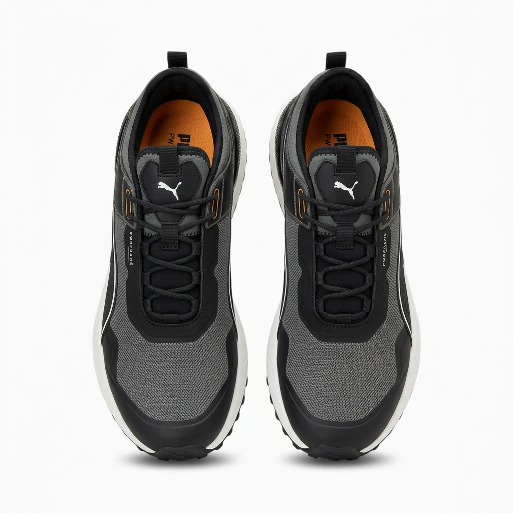 Pair of black and charcoal mesh lace-up sneakers with orange insoles