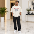 Man wearing cream oversized rose Perspective graphic tee