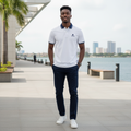 Young Nigerian male model wearing white polo with navy tipped collar and cuffs