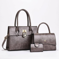 Deep-brown three-piece set with two top-handle handbags and snap wallet on white background