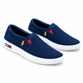 Pair of navy red-accent slip-on sneakers with white soles on white