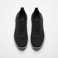 Black knit lace-up sneaker pair on white
