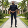 Nigerian male model wearing black suede slip-on sneakers with white sole in garden setting