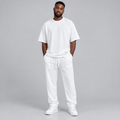 Nigerian male model wearing white oversized t-shirt and jogger tracksuit set