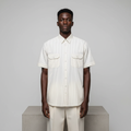 Nigerian male model wearing cream and brown pinstripe short-sleeved shirt