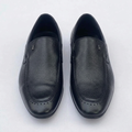 Straight-on black textured loafers with perforated toe borders