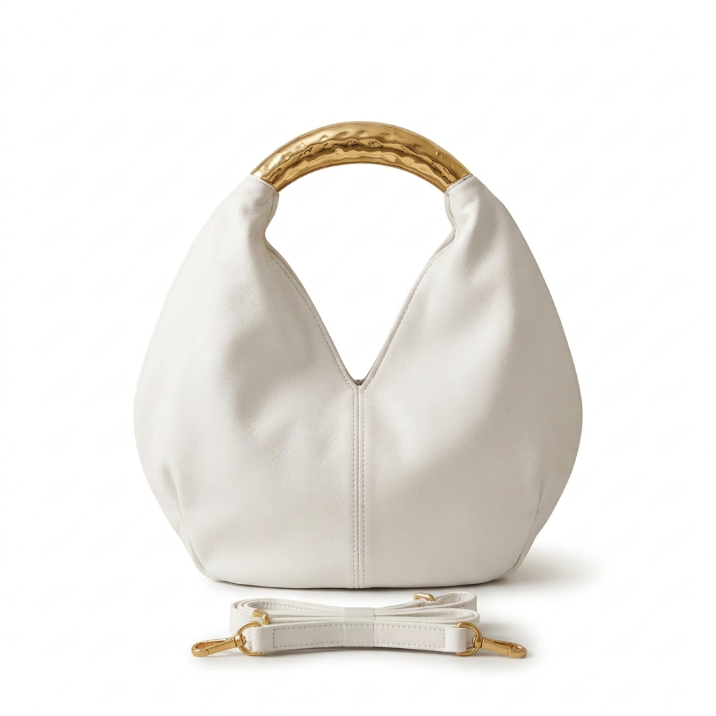 White rounded handbag without label, with gold-tone handle and matching strap on white