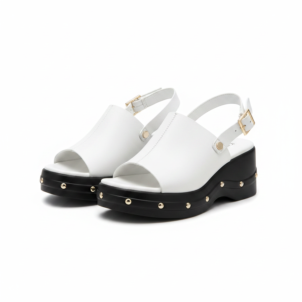 Pair of white leather open-toe platform wedge sandals with silver studded black sole and gold buckle