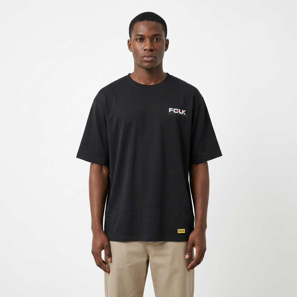 Model wearing black contrast-lettering T-shirt with yellow hem label