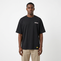Model wearing black contrast-lettering T-shirt with yellow hem label